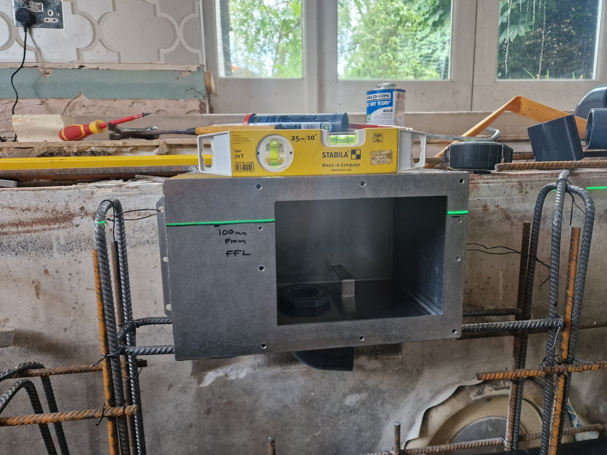 Pool skimmer being positioned with a laser level