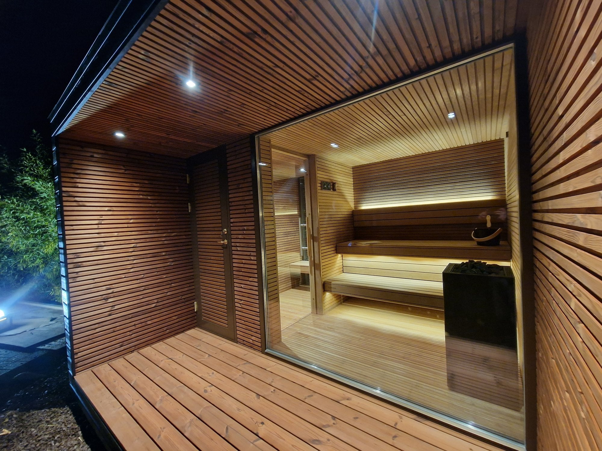 Illuminated garden sauna at night