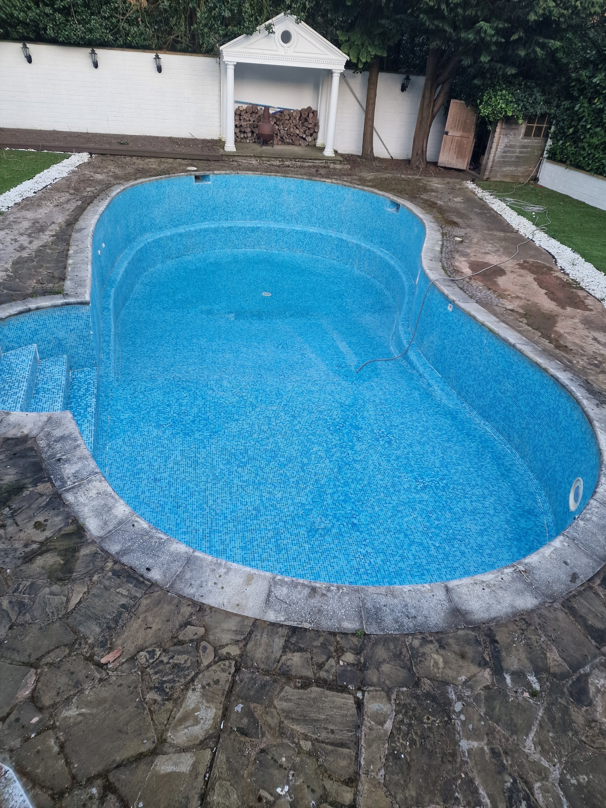 Outdoor swimming pool following cleaning and restoration